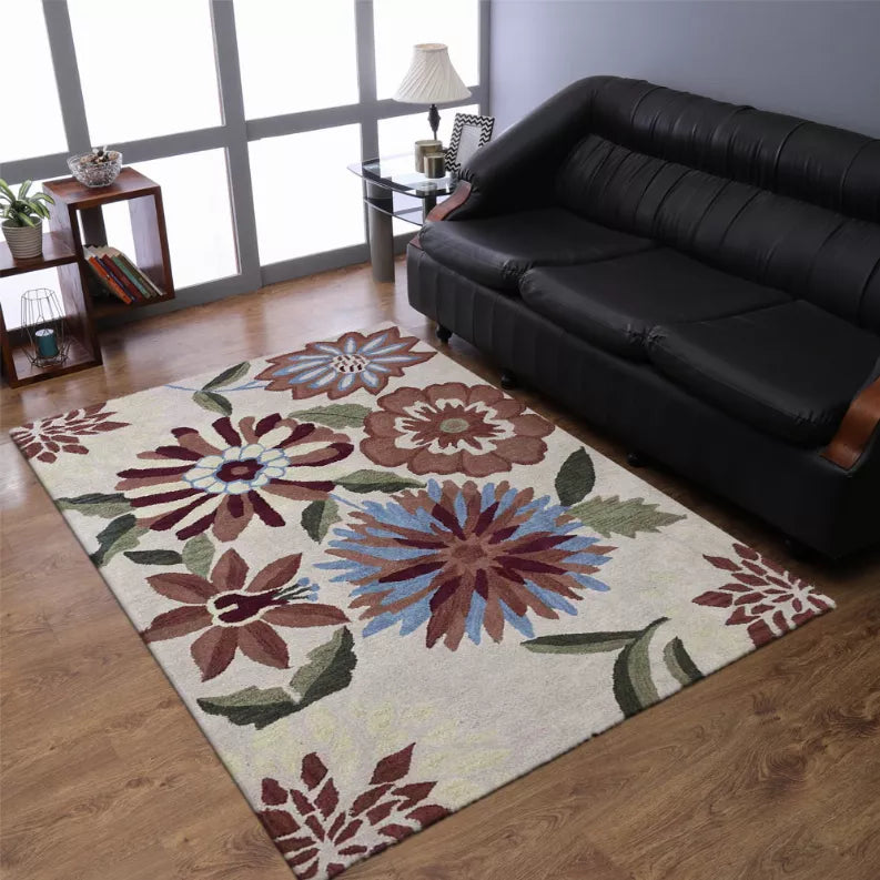 Hand-tufted shag area rug with multicolor flower motif on light background beside sofa