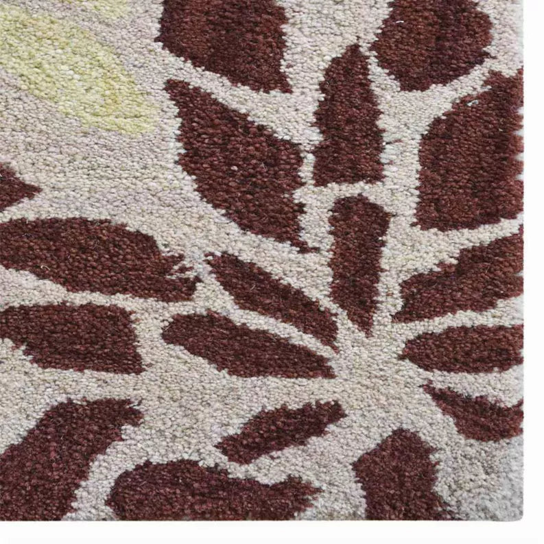 Hand-tufted shag area rug close-up with burgundy and cream geometric pattern