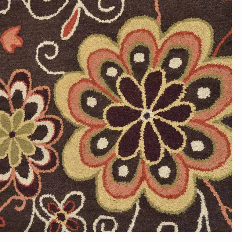 Close-up floral area rug: dark brown with large multicolor flower centerpiece and vines