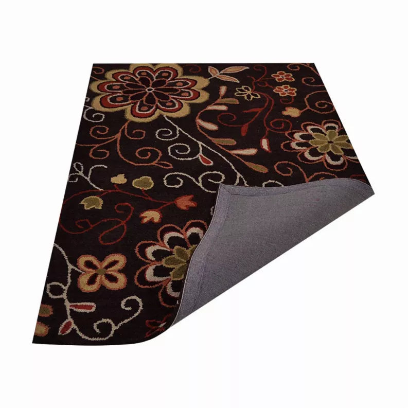 Reversible-style view of floral wool area rug corner showing gray backing