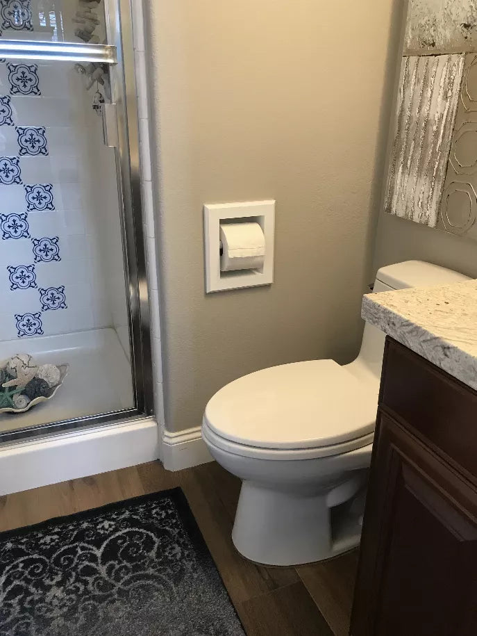 Recessed toilet paper holder with a single roll, built into the bathroom wall