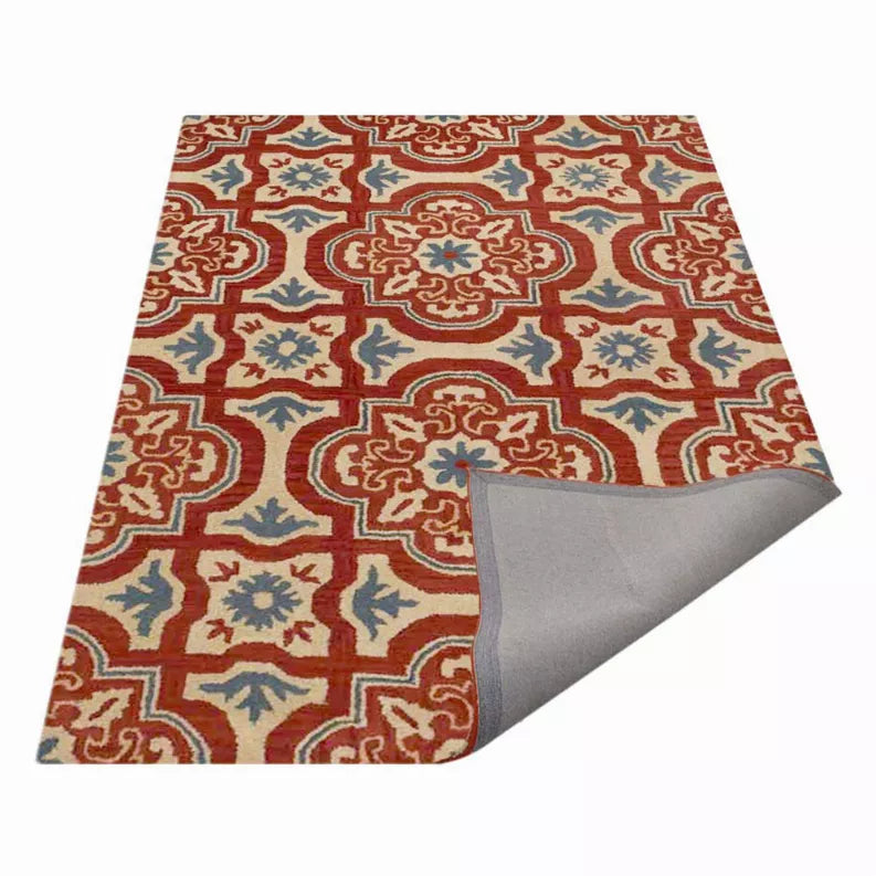 Floral area rug with red, blue, and cream medallion pattern; corner shows gray backing