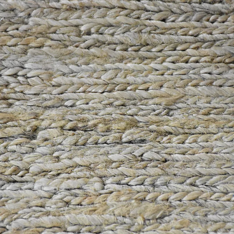 Braided jute area rug surface with solid beige and gray texture, close view