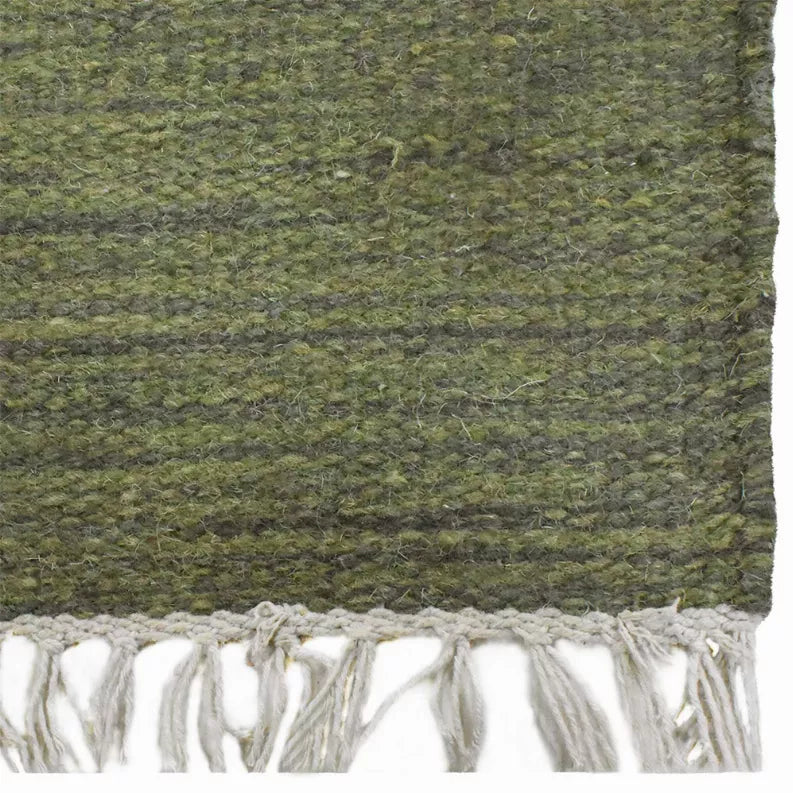 Olive green hand-woven wool kilim rug flat weave with white fringe on one side