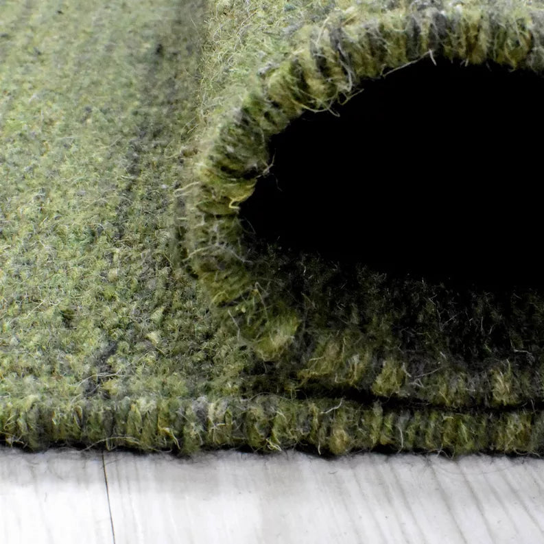 Olive green wool kilim rug with recessed looped center and textured weave edge
