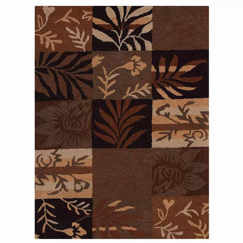 Square patchwork area rug with bold botanical leaf motifs in brown and tan panels