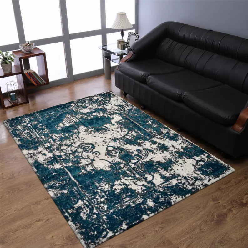 Abstract area rug in teal and off-white with vintage-style scrollwork pattern