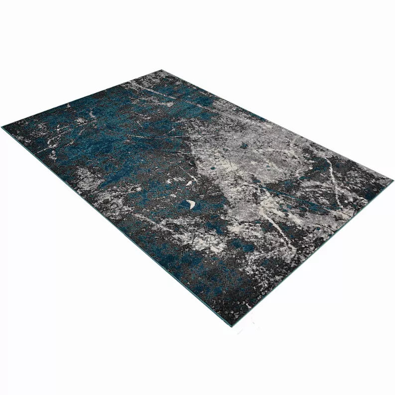 Abstract area rug with teal and gray distressed pattern, dark border edges
