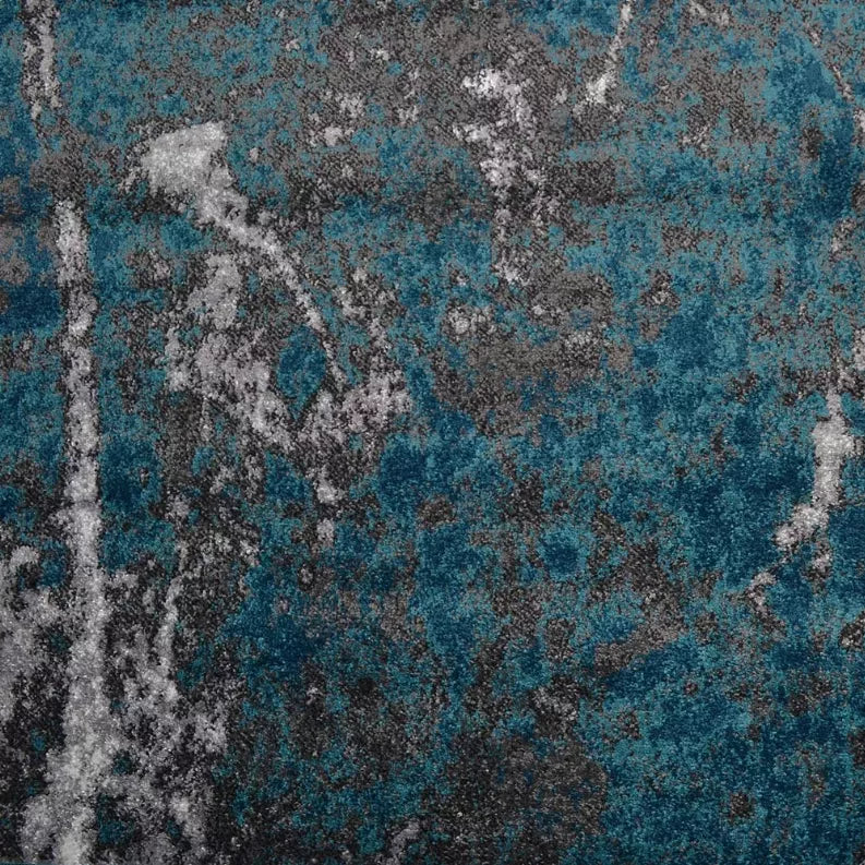 Close-up of abstract rug texture with teal blue and gray speckled pattern