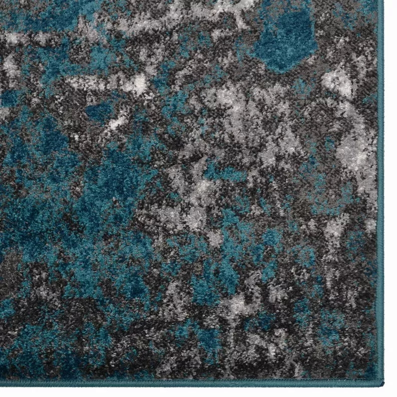 Abstract area rug corner with teal, gray, and dark distressed look