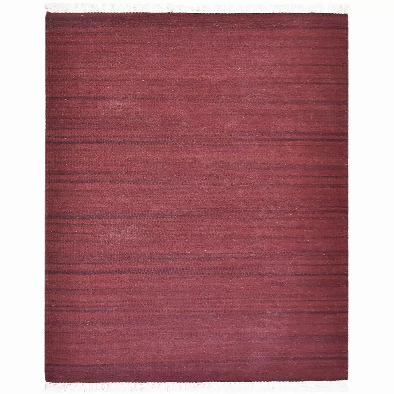 Burgundy wool kilim flatweave rug with fringe edges and solid striped texture