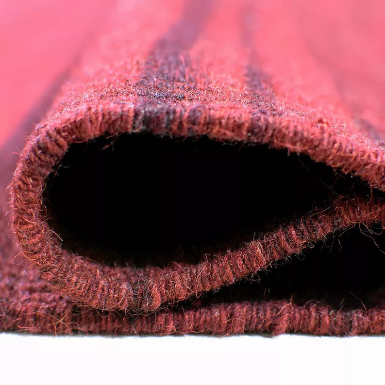 Burgundy rug edge showing underside opening and thick woven pile