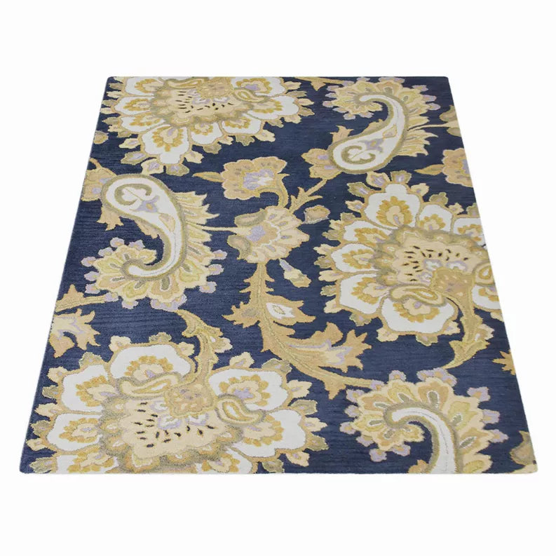 Ornate floral area rug with navy background and cream damask-style scroll pattern.