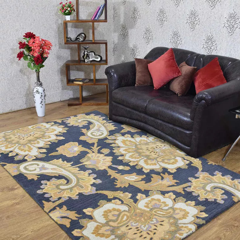 Navy hand-tufted wool area rug with ornate cream floral scroll pattern and decorative border.