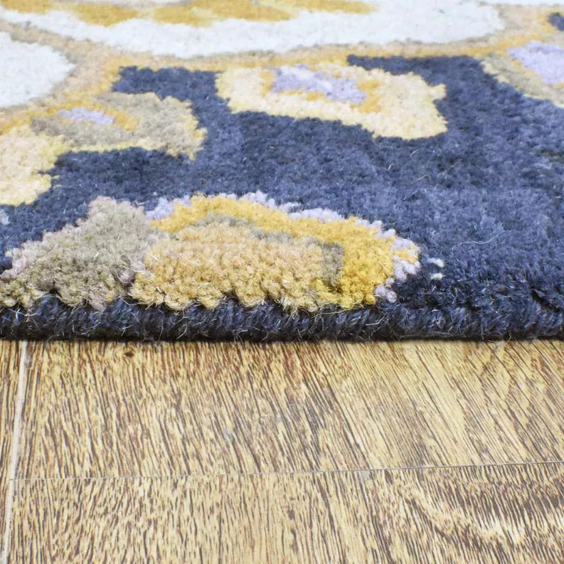 Hand-tufted wool rug close-up showing dense pile and navy floral motifs