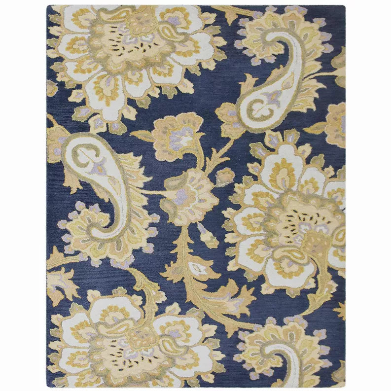 Hand-tufted wool area rug with navy base and light floral ornament pattern
