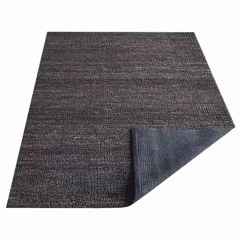 Charcoal hand-woven jute area rug, solid pattern with visible folded edge