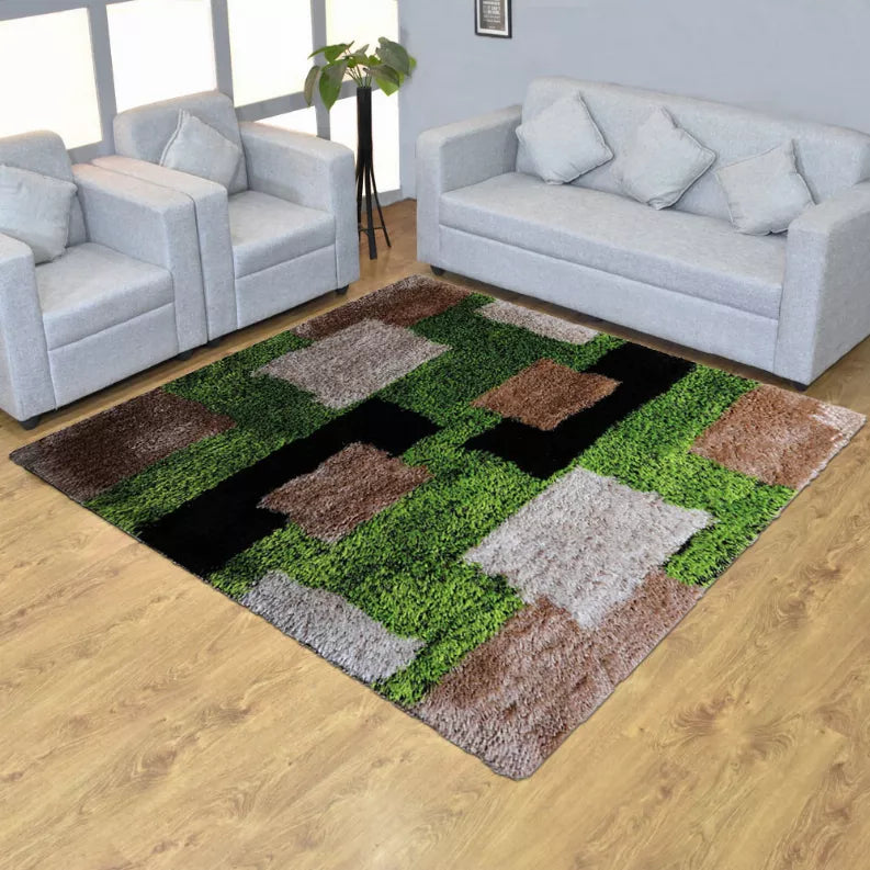 Square shag rug on wood floor featuring green, brown, gray, and black block pattern.