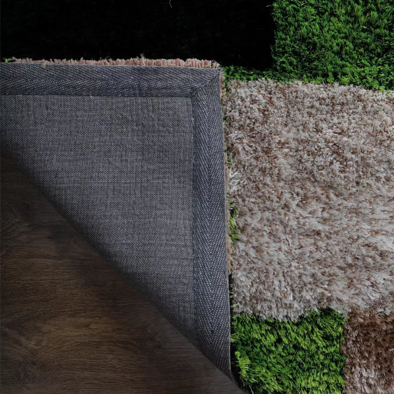 Shag rug edge with dark fabric backing showing on the side, green and gray pile.