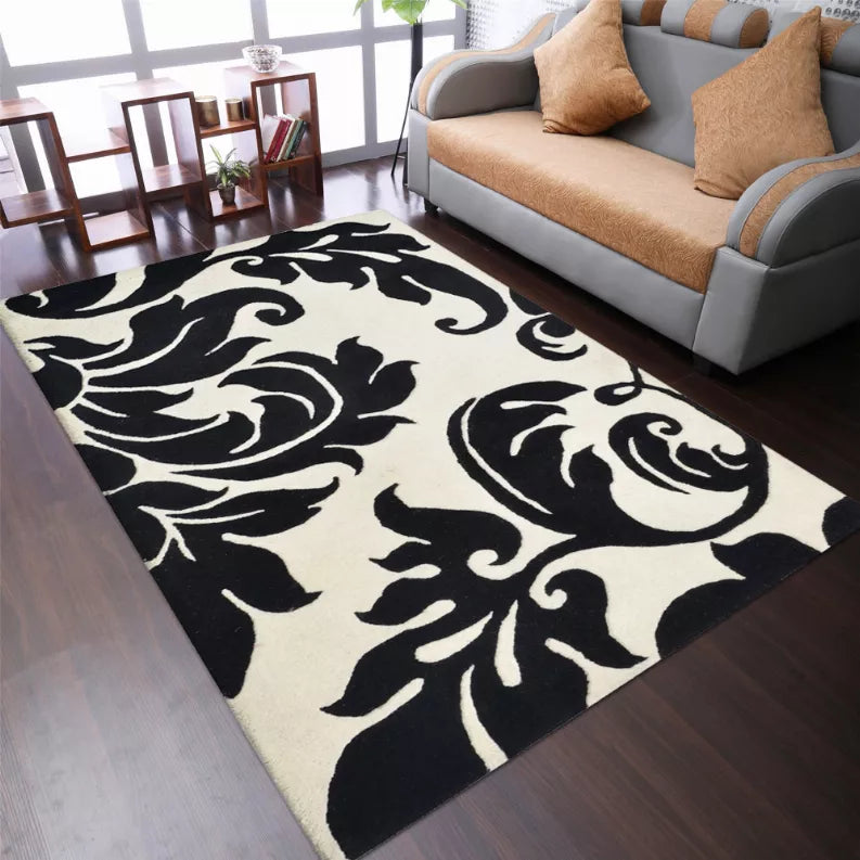 Floral area rug with bold black-and-ivory scrolling pattern, wide view