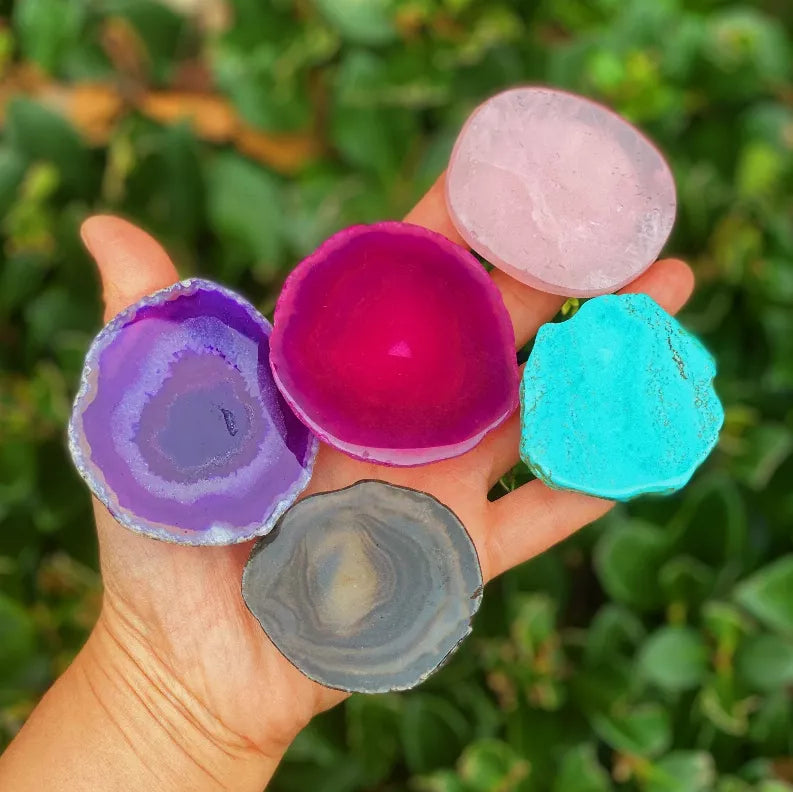 Hand holding five agate phone grips: purple, magenta, light pink, teal, gray