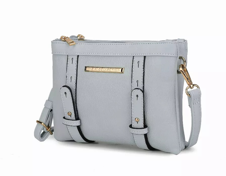 Light blue multi-compartment crossbody bag with gold hardware and adjustable strap