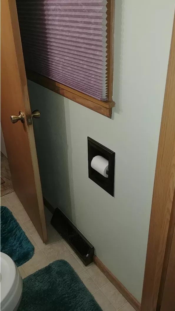 Recessed wood toilet paper holder with white frame and dark opening