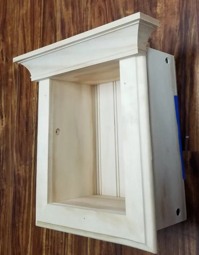 Recessed solid wood toilet paper holder mounted in wall recess, open front frame
