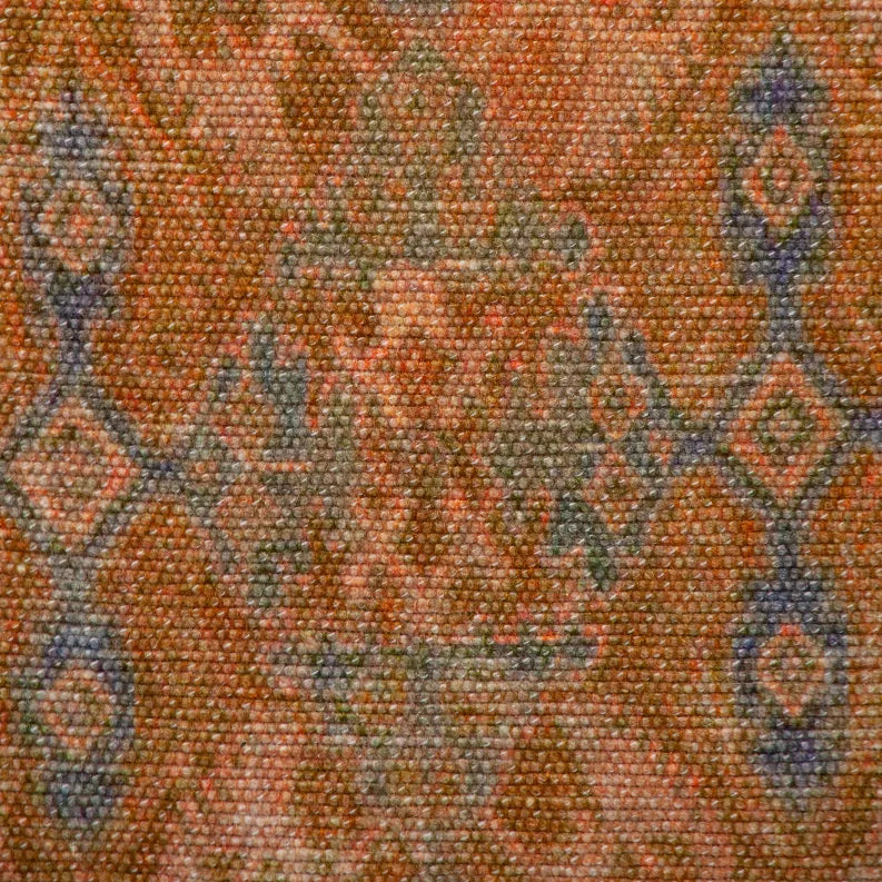 Close-up of woven tapestry fabric with orange base and blue gray motif