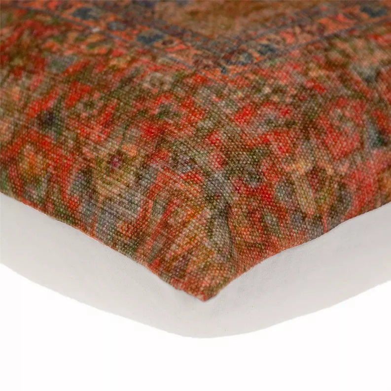 Corner of tapestry pillow with multicolor textured weave and stitched trim