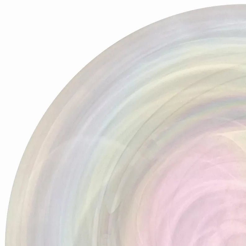 Glass charger plate edge close-up with soft pastel swirl streaks in lavender and mint