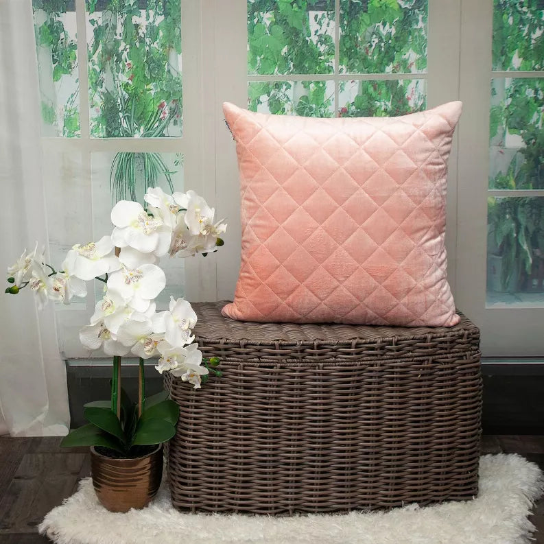 Dusty rose quilted throw pillow featuring a diamond quilt pattern on the front