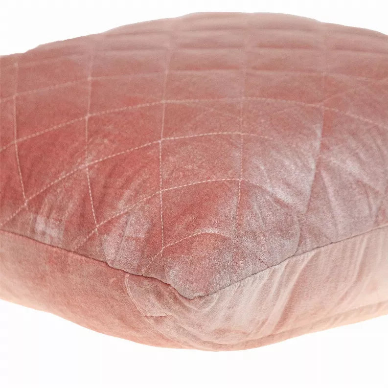 Blush pink quilted pillow close-up, diamond stitched top surface