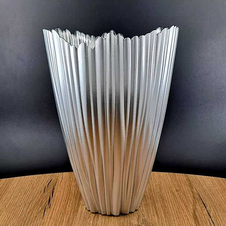 Clear glass vase with vertical fluted ridges and silver-tone finish