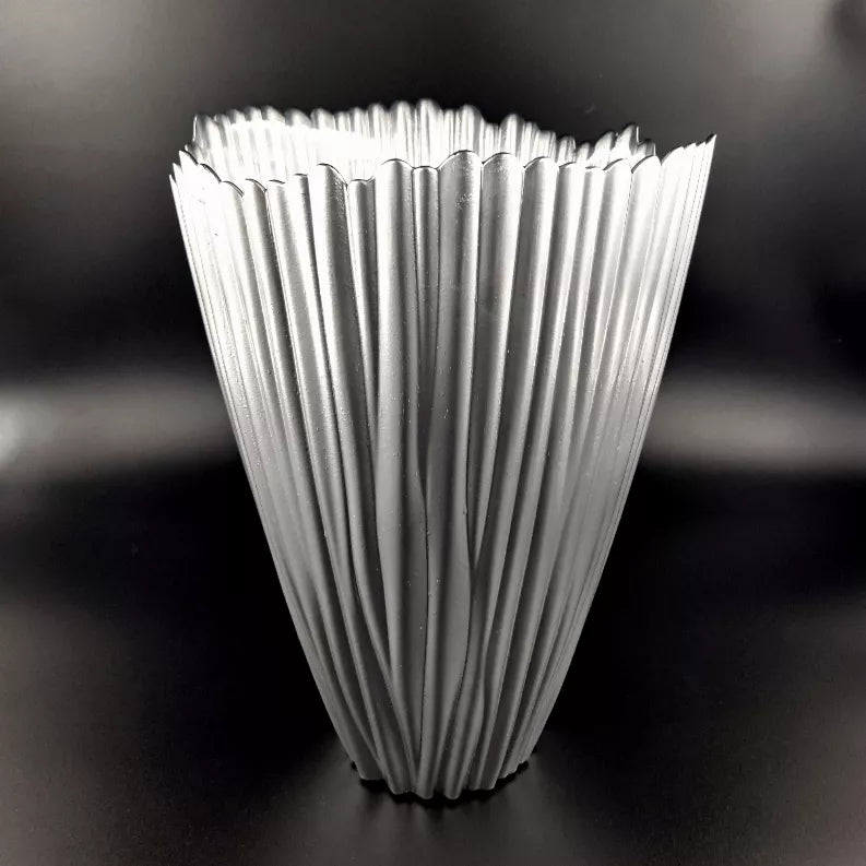 Front view of fluted clear glass vase with reflective silver ridges