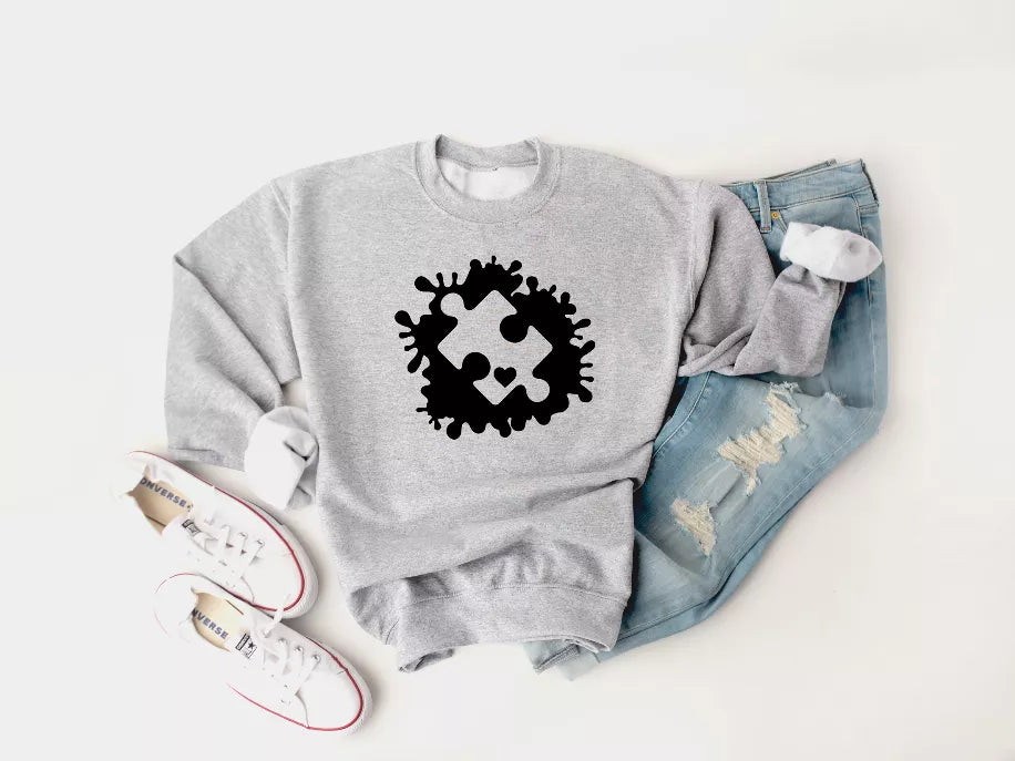 Heather gray crewneck sweatshirt with black puzzle-piece autism graphic
