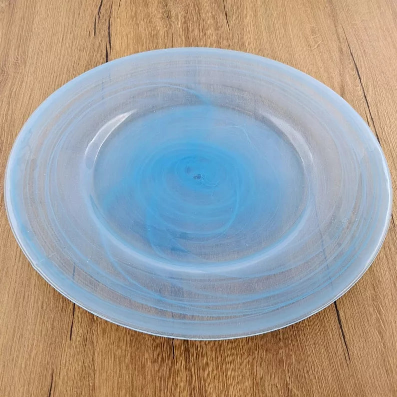 NUAGE 13" glass charger plate on wood, light blue swirl pattern, glossy.