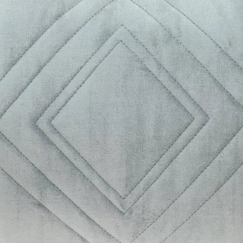 Close-up of light gray-blue quilted diamond stitch pattern on throw pillow