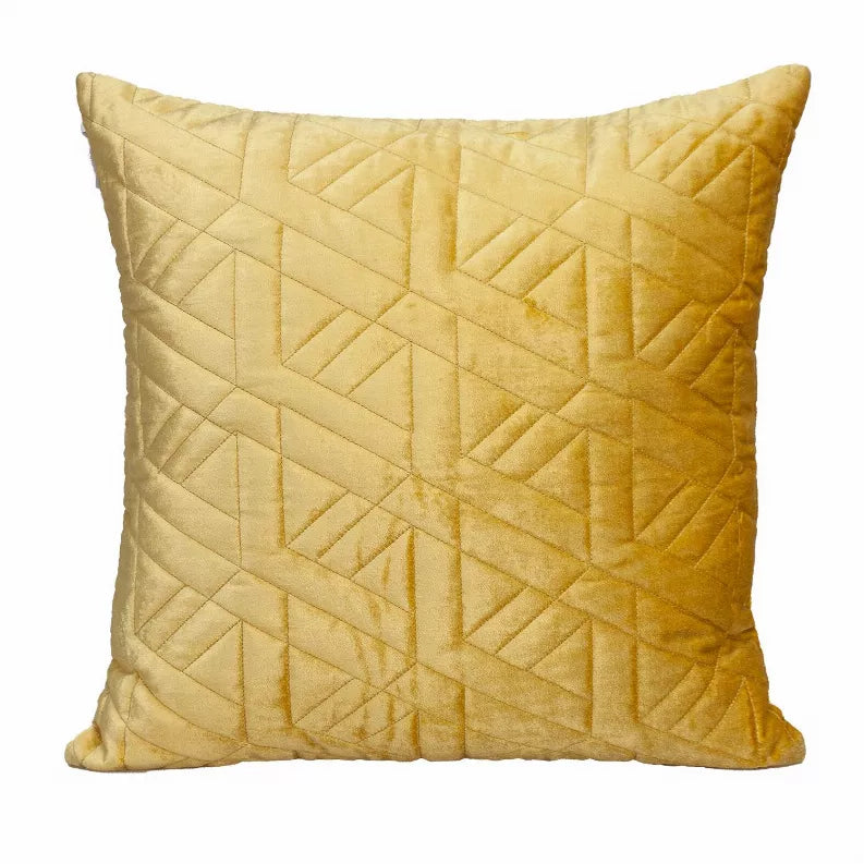 Mustard yellow quilted throw pillow with geometric pattern front and stitched border