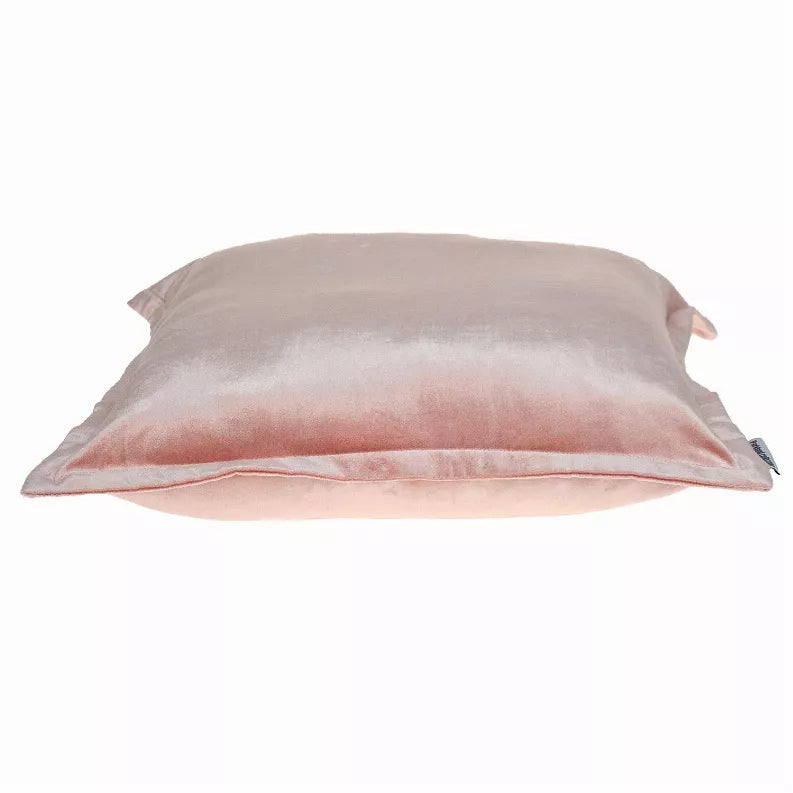 Blush pink throw pillow on its side, horizontal seam line, soft sheen fabric