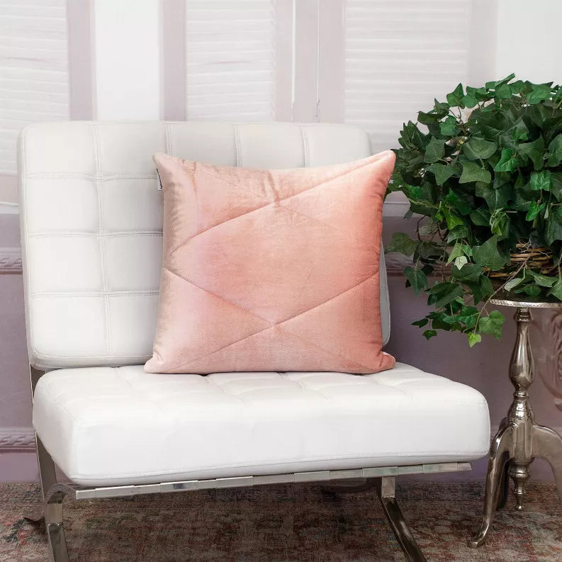 Pink quilted throw pillow with diamond stitched pattern and piped edges