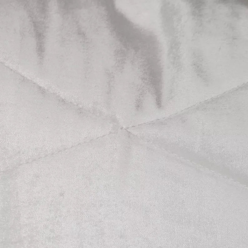 Close-up of light gray quilted pillow fabric with stitched channel lines