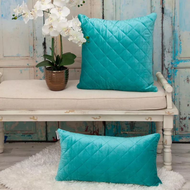 Turquoise quilted throw pillow set on a bench and shelf, shown with two pillow sizes.
