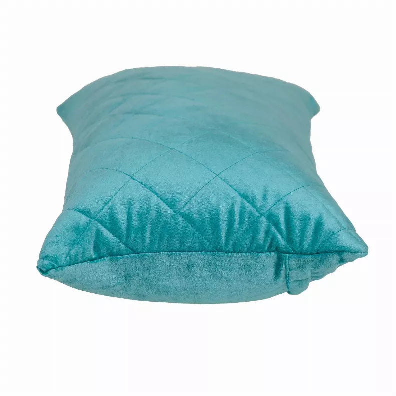 Turquoise quilted throw pillow with diamond stitching, shown from a side angle close-up.