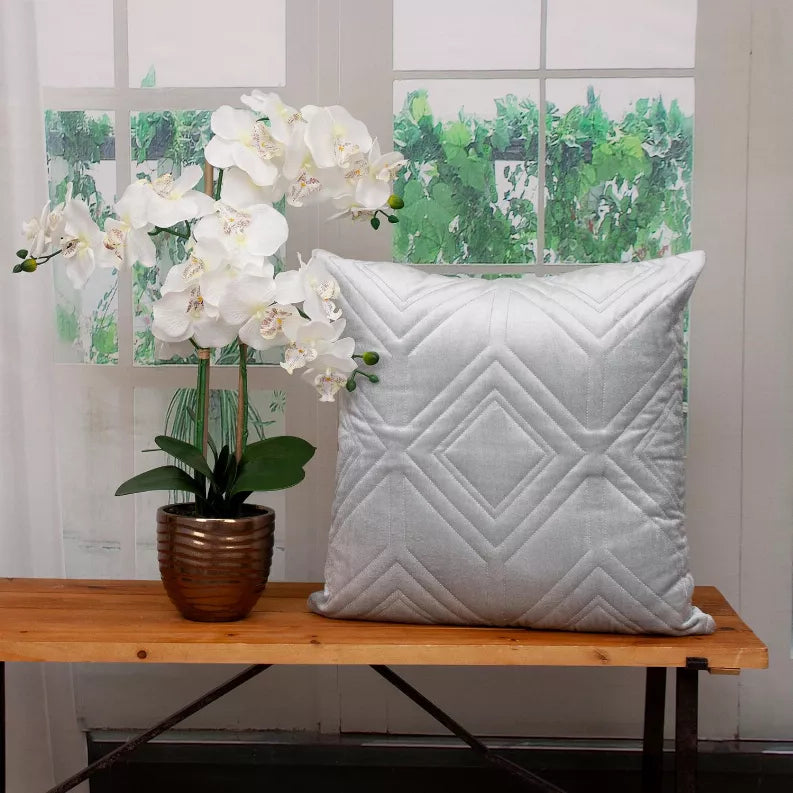 White quilted throw pillow with diamond and chevron stitched pattern