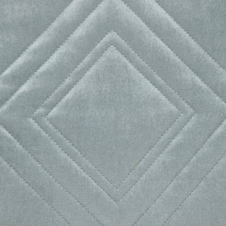 Close-up of blue-gray quilted throw pillow with diamond quilting and channel seams