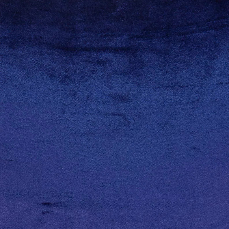 Royal blue velvet-like throw pillow fabric close-up with soft, mottled nap.