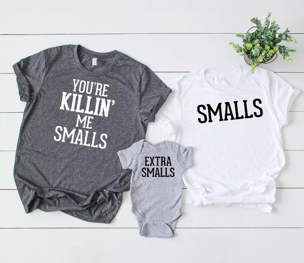 Dark gray crewneck tee with 'YOU'RE KILLIN' ME SMALLS' print; gray 'EXTRA SMALLS' onesie