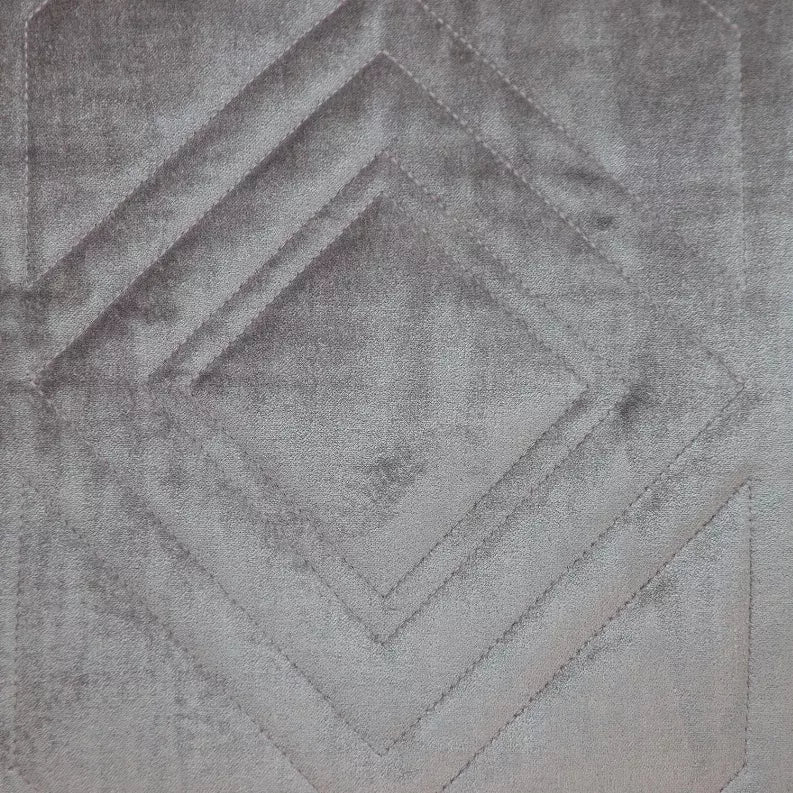 Light gray quilted pillow cover with repeating diamond and chevron stitching