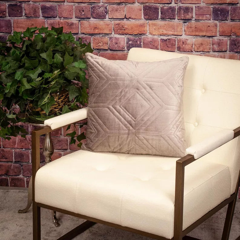 Beige quilted accent pillow with stitched diamond design and piped edges